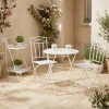 Conjunto de mesa e duas cadeiras em metal com folhas branco