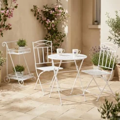 Conjunto de mesa e duas cadeiras em metal com folhas branco